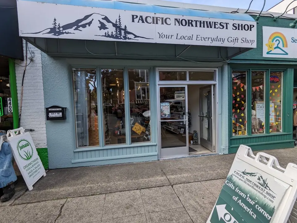 The open Seattle shop beneath its mountain logo sign