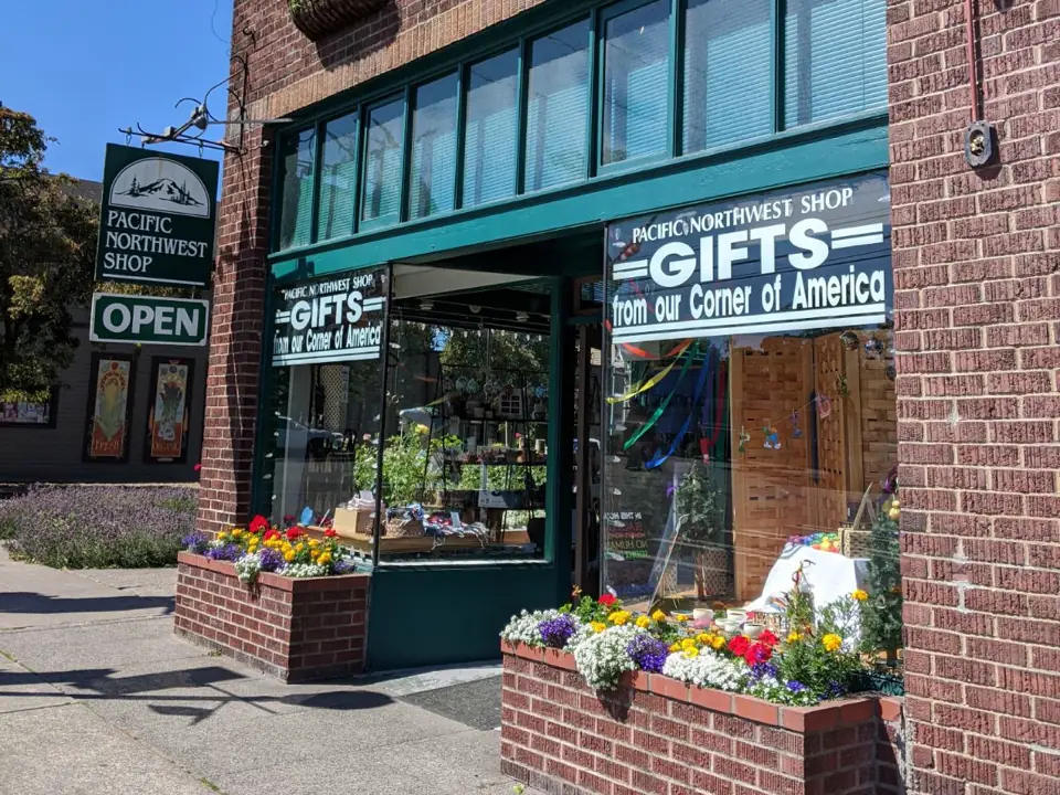 The Tacoma shop's entrance, between brick planters of flowers
